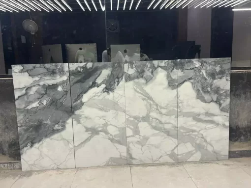 Glacier White Glossy 24x48 Porcelain Tile — a large-format glossy white tile featuring a sleek, reflective surface that enhances light and creates a spacious, modern aesthetic. Perfect for walls and floors in kitchens, bathrooms, and contemporary living areas. Each box contains 2 pieces covering 16 sq ft. Durable, elegant, and easy to maintain.