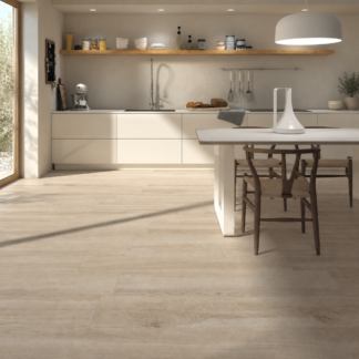 Kalon Haya wood-look porcelain tile in a cream kitchen with dark wood chairs and natural sunlight.