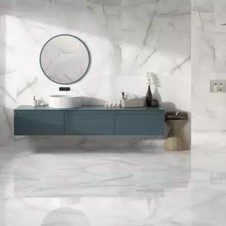 Baltra Pearl Polished Porcelain Tile — a luxurious marble-look porcelain in elegant pearl-white tones with subtle veining and a brilliant polished finish. Its glossy surface enhances brightness and sophistication while ensuring durability, water resistance, and easy maintenance. Perfect for stylish floors and walls in kitchens, bathrooms, and modern living areas.
