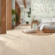 Argentario Betulla 8x48 Wood Look Porcelain Tile featuring light beige wood-look flooring in a modern bedroom with natural decor and soft lighting.