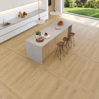 Versat Haya Wood Look Porcelain Tile by STN Cerámica installed in a modern kitchen featuring warm beige wood-look flooring, a white kitchen island, and natural light.