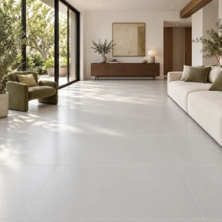 Essenza Perla Satin pearl-gray porcelain flooring in a living room with cream seating and garden views.